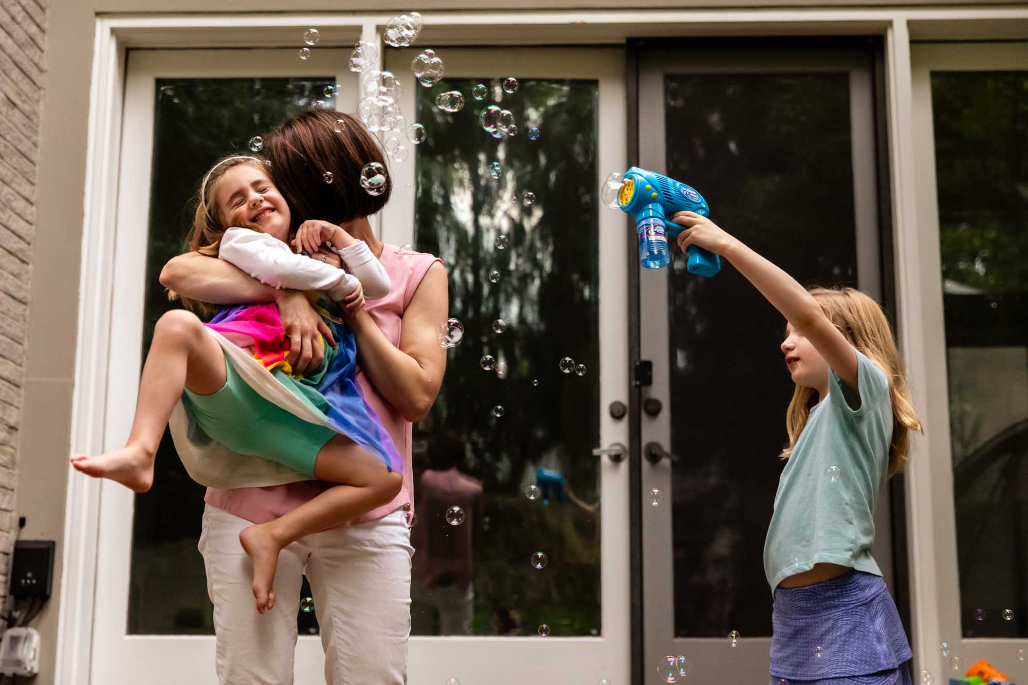 kids playing in the backyard with bubbles at a birthday party in pittsburgh